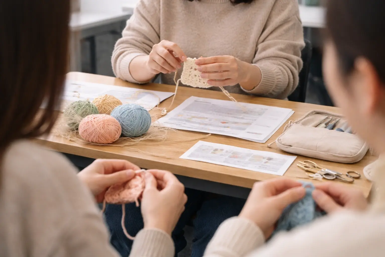 Teacher demonstrating crochet technique in an educational setting